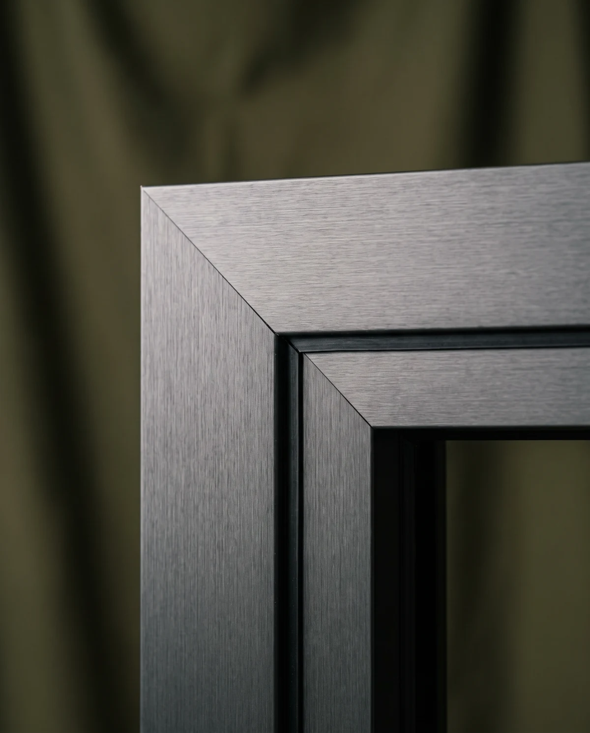 Macro view of a brushed anthracite aluminium window frame corner with thermal break (AI-generated)