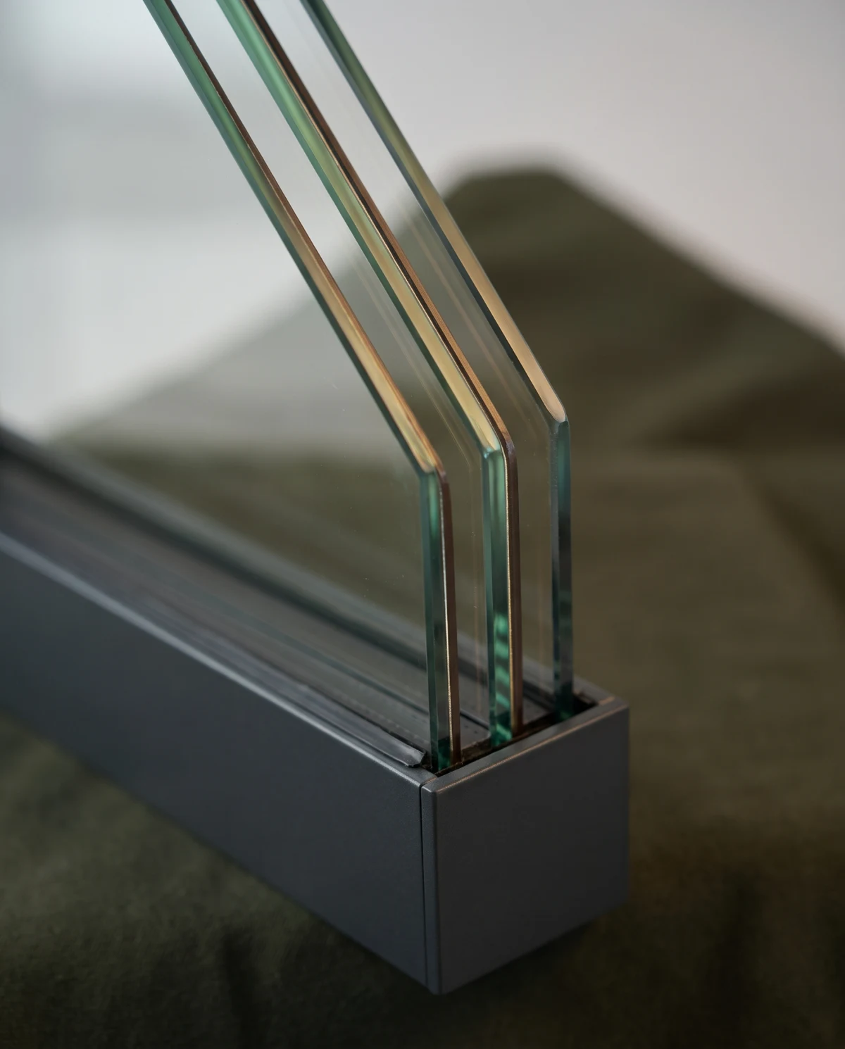 Edge of a triple-glazing unit with warm-edge spacers in a slim aluminium frame (AI-generated)